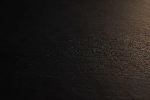 Dark Textured Surface With Warm Light
