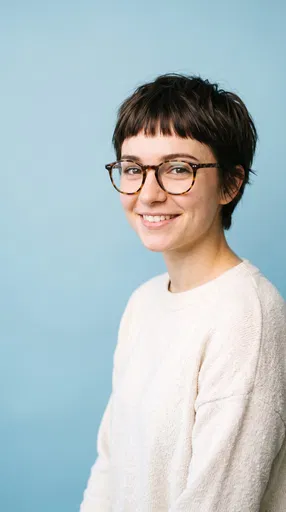 Smiling Woman With Pixie Cut and Glasses