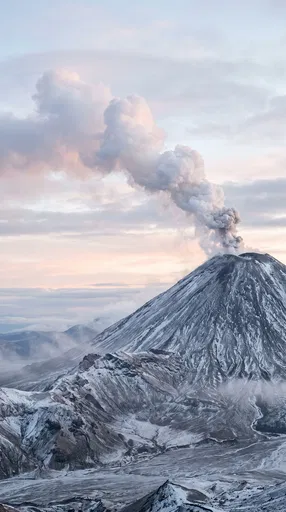 Steaming Snow-Dusted Stratovolcano at Dawn