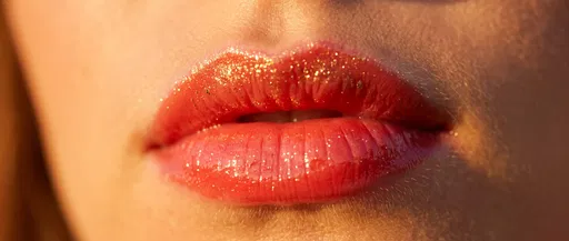 Macro Glossy Coral Lips with Gold Shimmer