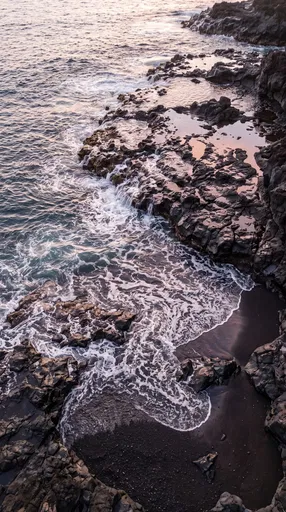 Waves Over Volcanic Basalt Rocks at Sunset