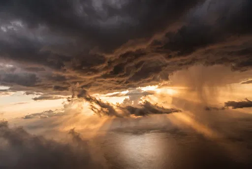 Dramatic Sunset Sunbeams Through Storm Clouds