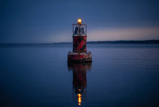Glowing Maritime Hazard Buoy at Blue Hour