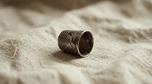 Tarnished Silver Thimble on Linen