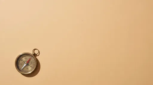 Brass Compass on Warm Sand Backdrop