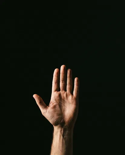 Raised Open Hand on Black Background