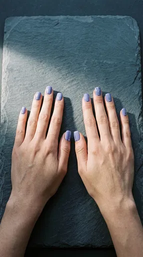 Hands With Periwinkle Nail Art On Slate