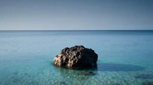 Solitary Volcanic Boulder in Calm Turquoise Ocean