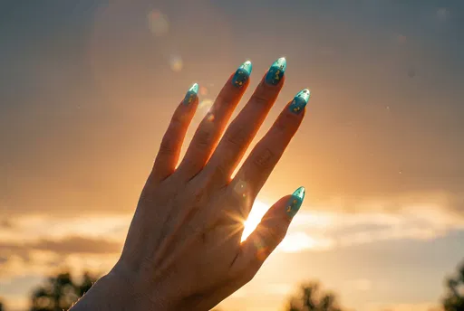 Hand With Aqua Jelly Nails at Sunset