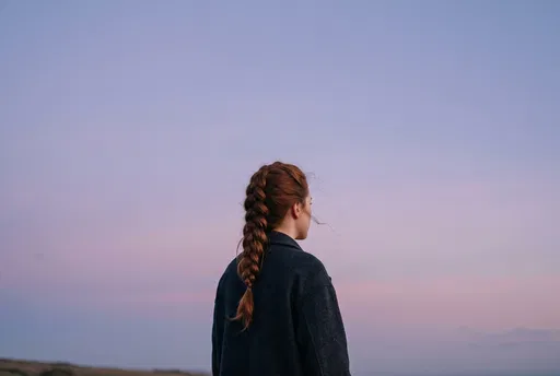 Woman with Braided Red Hair at Dusk