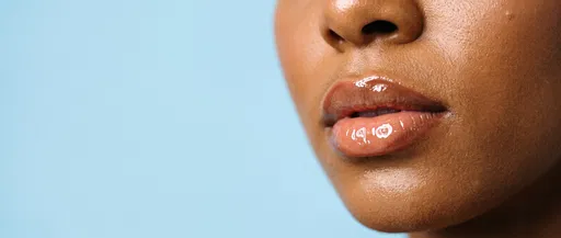 Close-Up of Glossy Lips on Blue