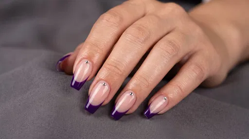 Woman Hand With Purple French Tip Manicure
