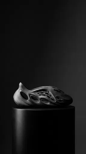 Sculpted Charcoal Foam Sneaker on Black Pedestal
