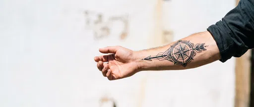 Man's Forearm With Blackwork Compass Tattoo