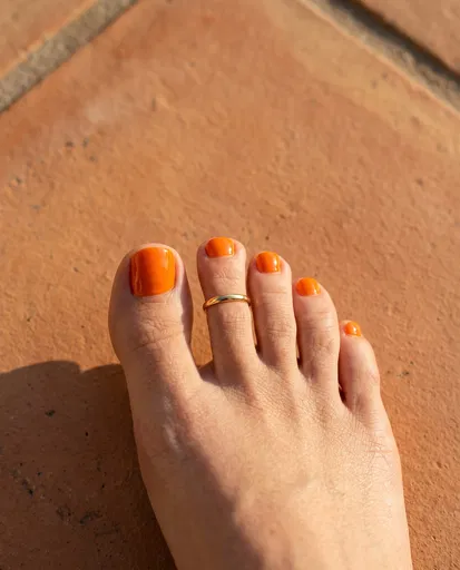 Bare Foot With Orange Polish and Toe Ring