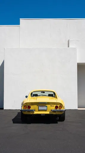 Vintage Yellow Sports Car Against White Wall