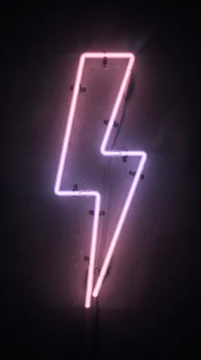 Pink Neon Lightning Bolt Sign on Wall
