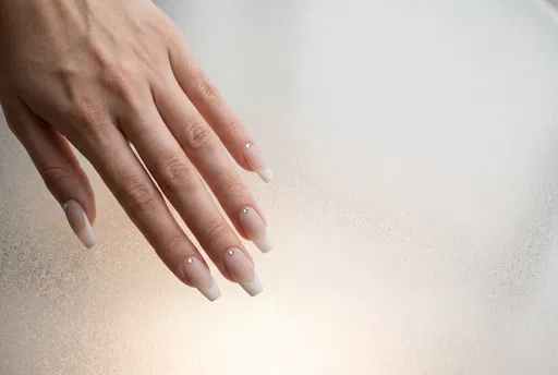 Woman Hand With Matte French Coffin Nails