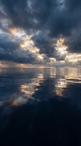 Dramatic Storm Clouds Reflecting on Calm Ocean