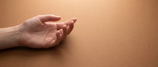 Open Hand on Warm Brown Background