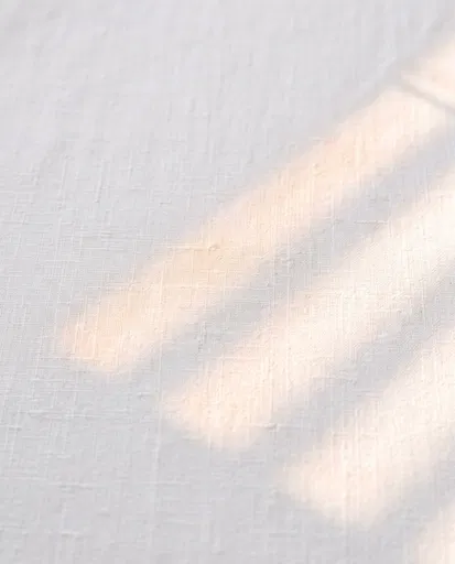 White Linen Fabric With Warm Sunlight Shadows