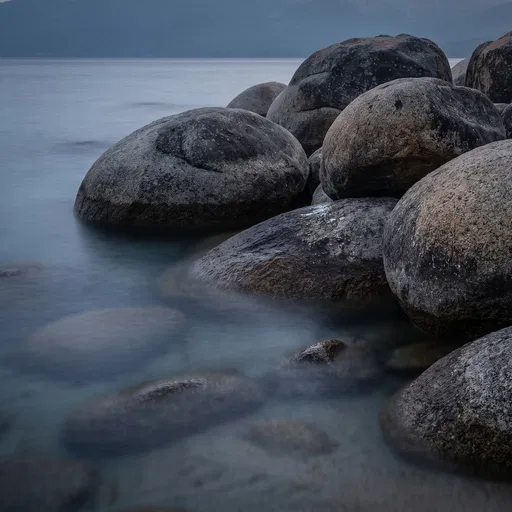 Granite Boulders in Calm Lake Water