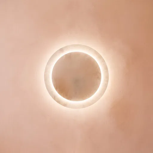 Glowing Circular Mirror on Pastel Peach Wall