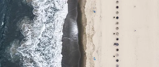 Aerial View of Beach Shoreline and Fire Rings