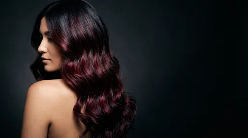 Woman With Burgundy Balayage Wavy Hair