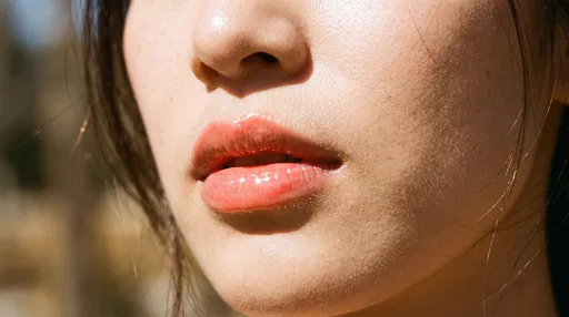 Close-Up of Glossy Coral Lips in Sunlight