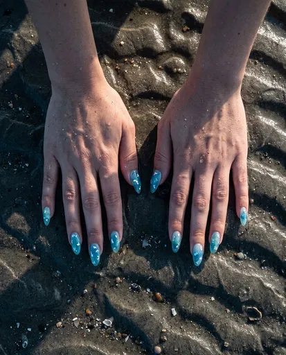 Hands With Blue Nail Art on Sand