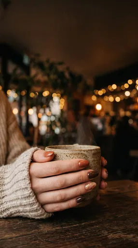 Hands Holding Ceramic Mug With Earthy Manicure