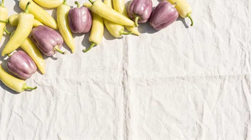 Yellow and Purple Peppers on Linen