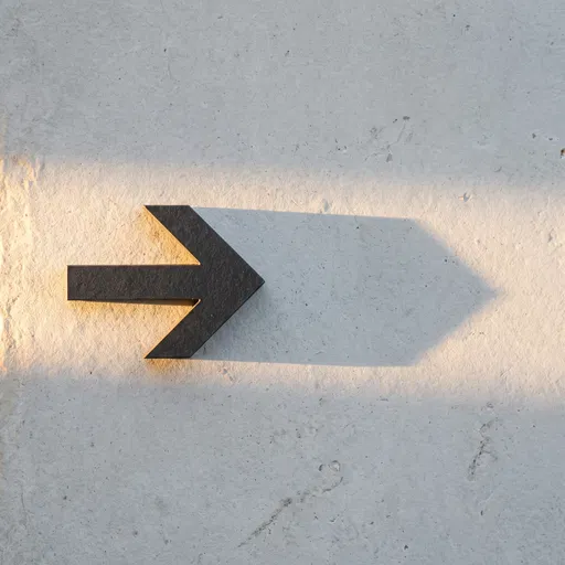 Charcoal Right Arrow on Stone Surface