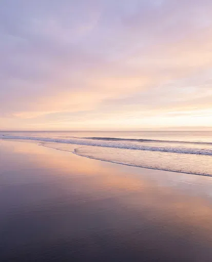 Pastel Sunrise Reflecting on Wet Beach