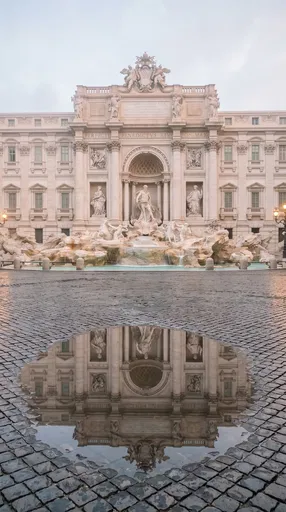 Trevi Fountain Reflected in Cobblestone Puddle