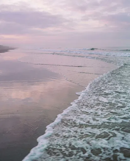 Pastel Dawn Waves on Reflective Sand