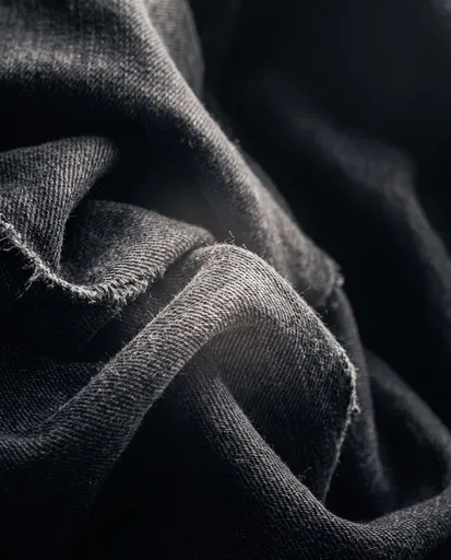 Monochrome Charcoal Denim Fabric Folds Close-Up
