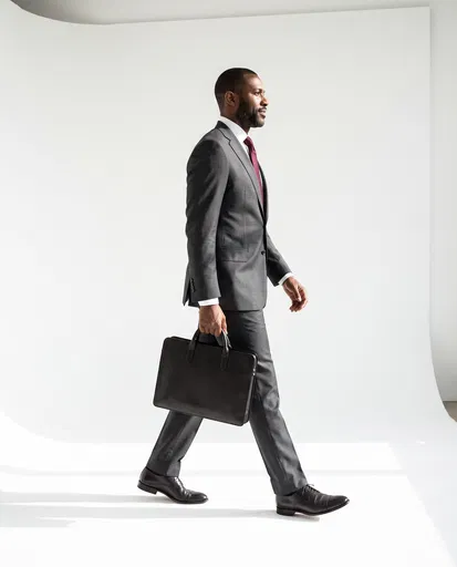 Businessman Walking in Profile with Briefcase
