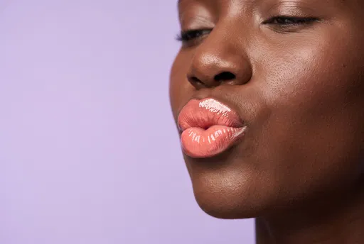 Woman Wearing Glossy Coral Lipstick