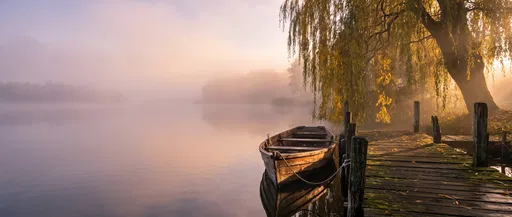 Rowboat at Misty Autumn Lake Dock
