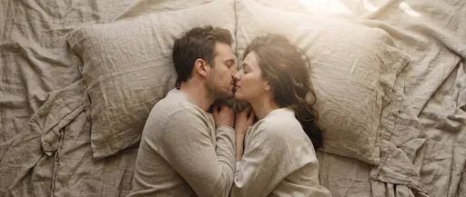Couple Kissing on Beige Linen Bedding