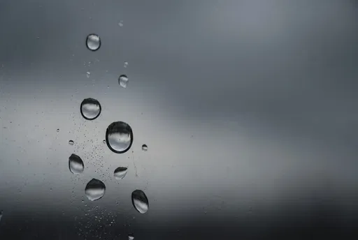 Sparse Raindrops on Moody Window Pane