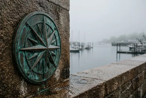Weathered Bronze Compass Plaque on Harbor Wall