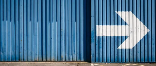 White Arrow on Blue Corrugated Wall