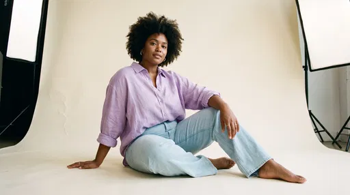Curvy Woman in Jeans Sitting in Studio