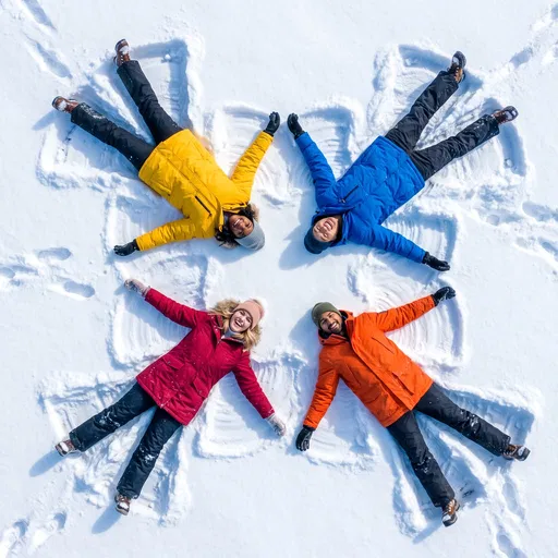 Four Friends Making Snow Angels Overhead
