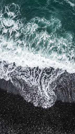 Aerial View of Waves on Black Beach