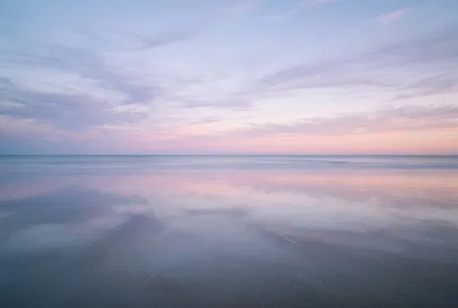 Minimalist Pastel Sunset Over Reflective Beach