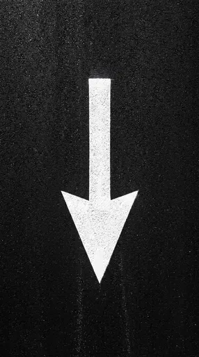 White Downward Arrow on Black Asphalt